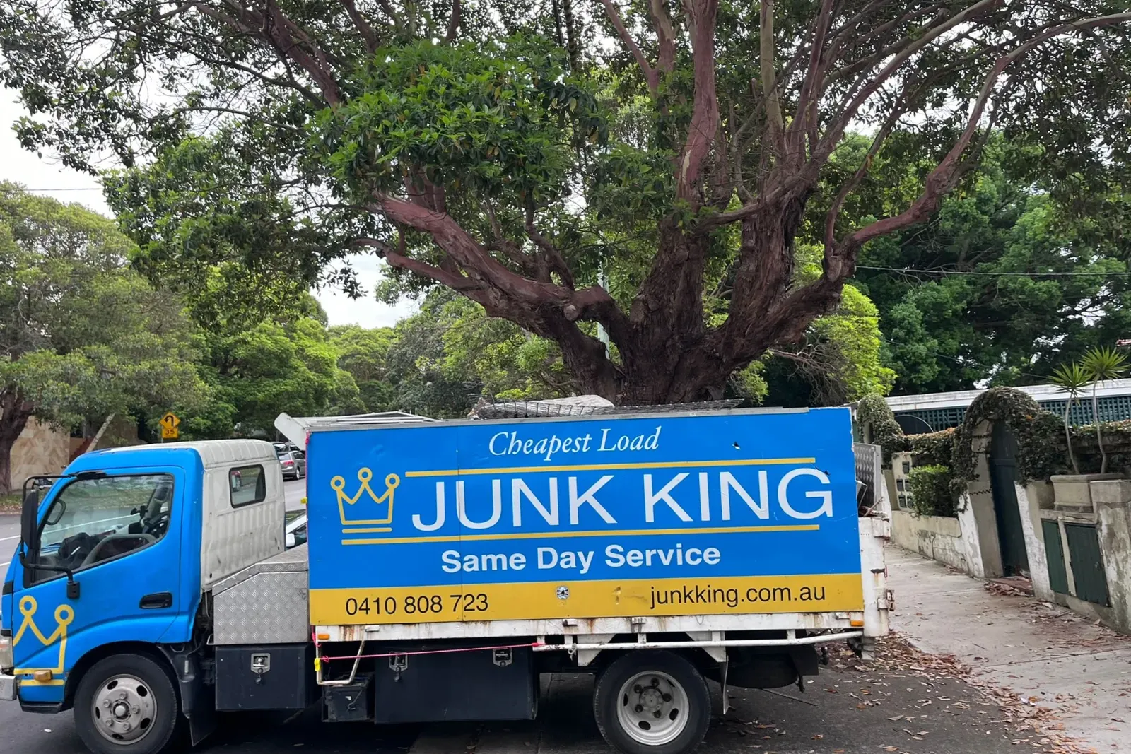 Junk King truck parked on a leafy Sydney street